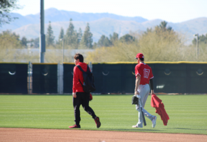 Shohei Ohtani and Ippei Mizuhara walking away from viewer at spring training 2020.