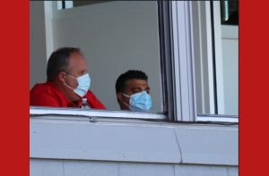 Perry Minasian in a mask watching a game