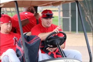 Mike Trout driving a golf cart with Kole Calhoun riding shotgun