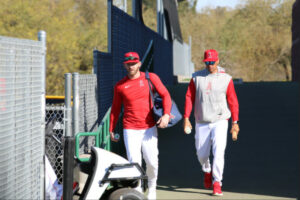 Taylor Ward at spring training Feb. 19, 2024. Red top, white pants, and gear bag on shoulder.