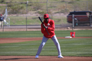 Ron Washington choked up on a bat hitting a grounder for infield practice